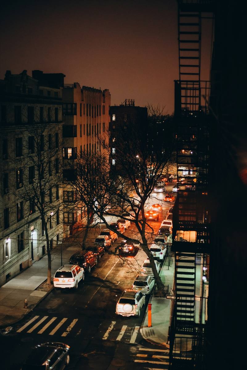 Night view over a Bronx street from a fire escape