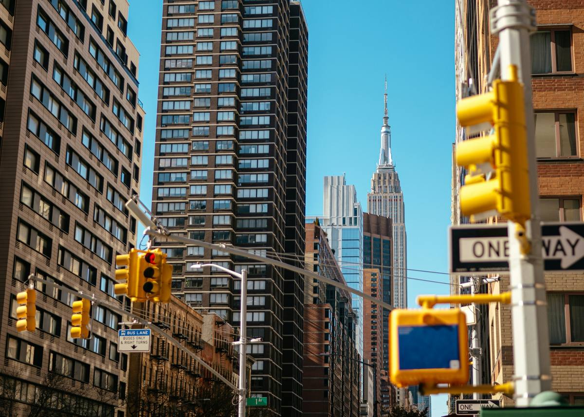Street-level view up a Manhattan avenue toward the Empire State Building