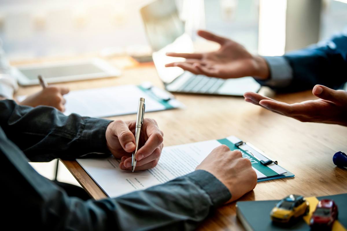 Two people reviewing an agreement across a desk