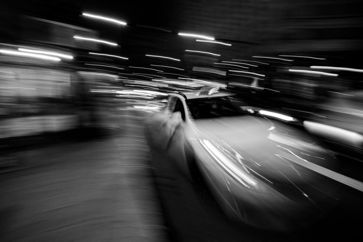 Car passing at night in a long-exposure blur