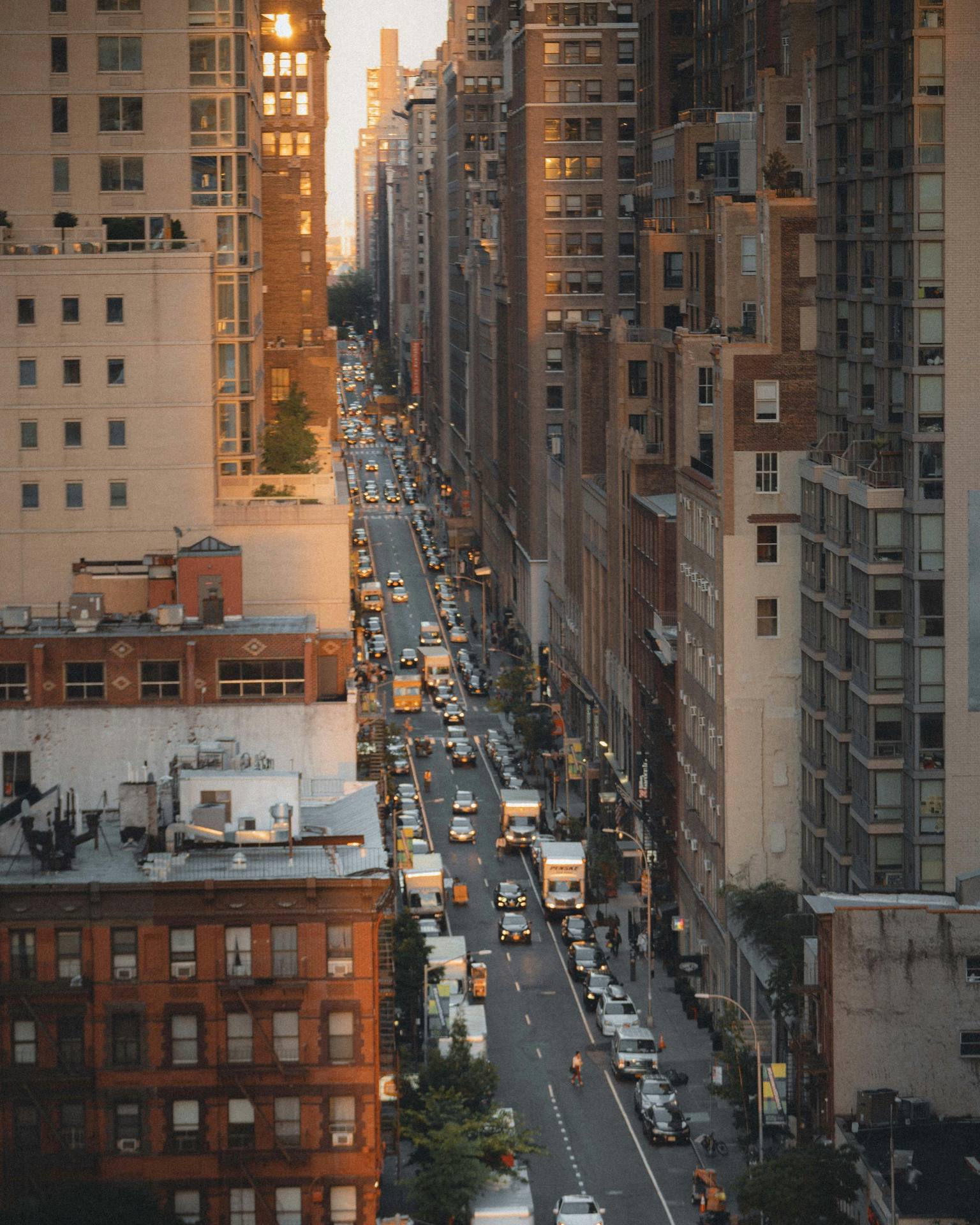 Aerial view of a Manhattan avenue filled with dusk traffic