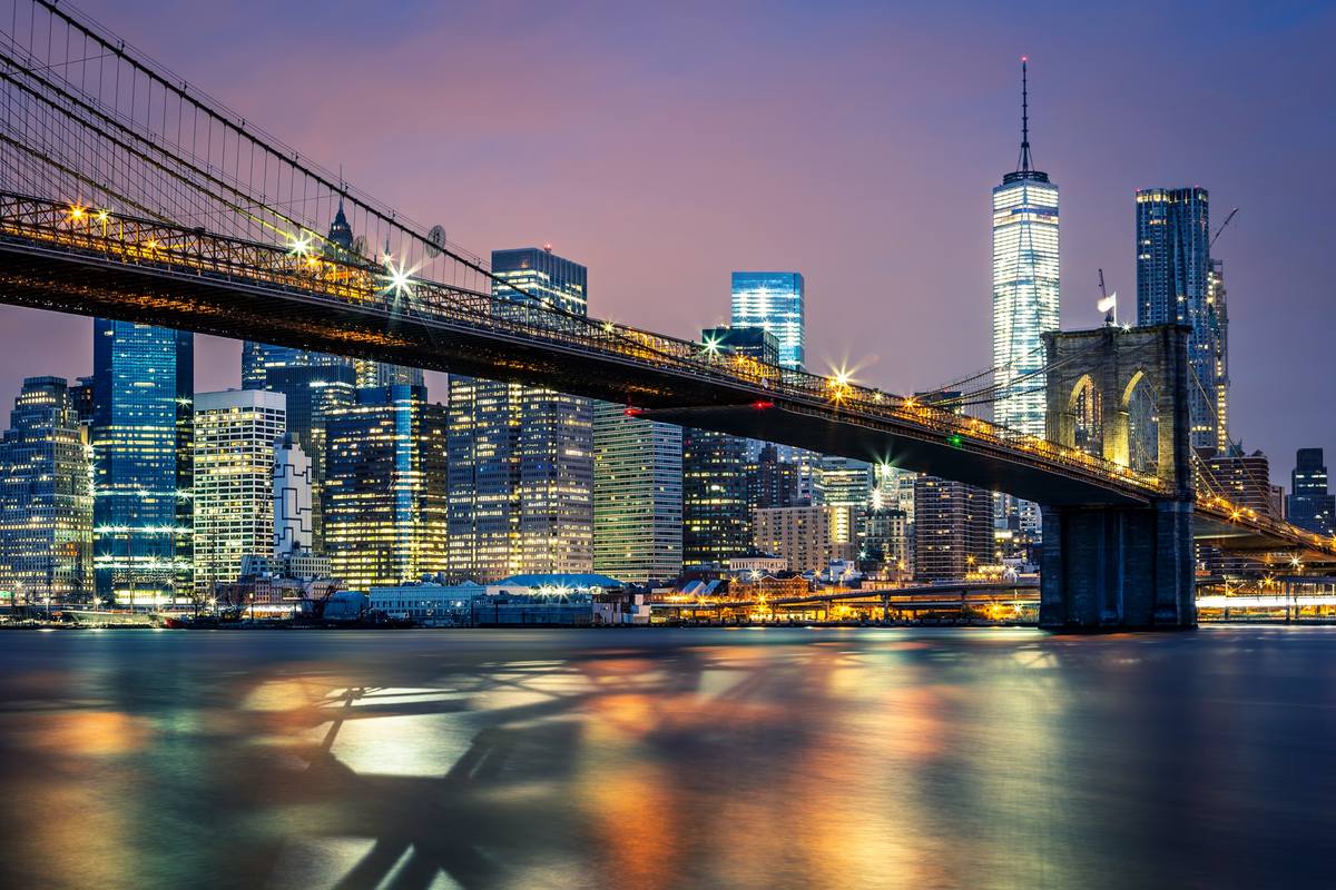 The Brooklyn Bridge and Manhattan skyline lit up at night