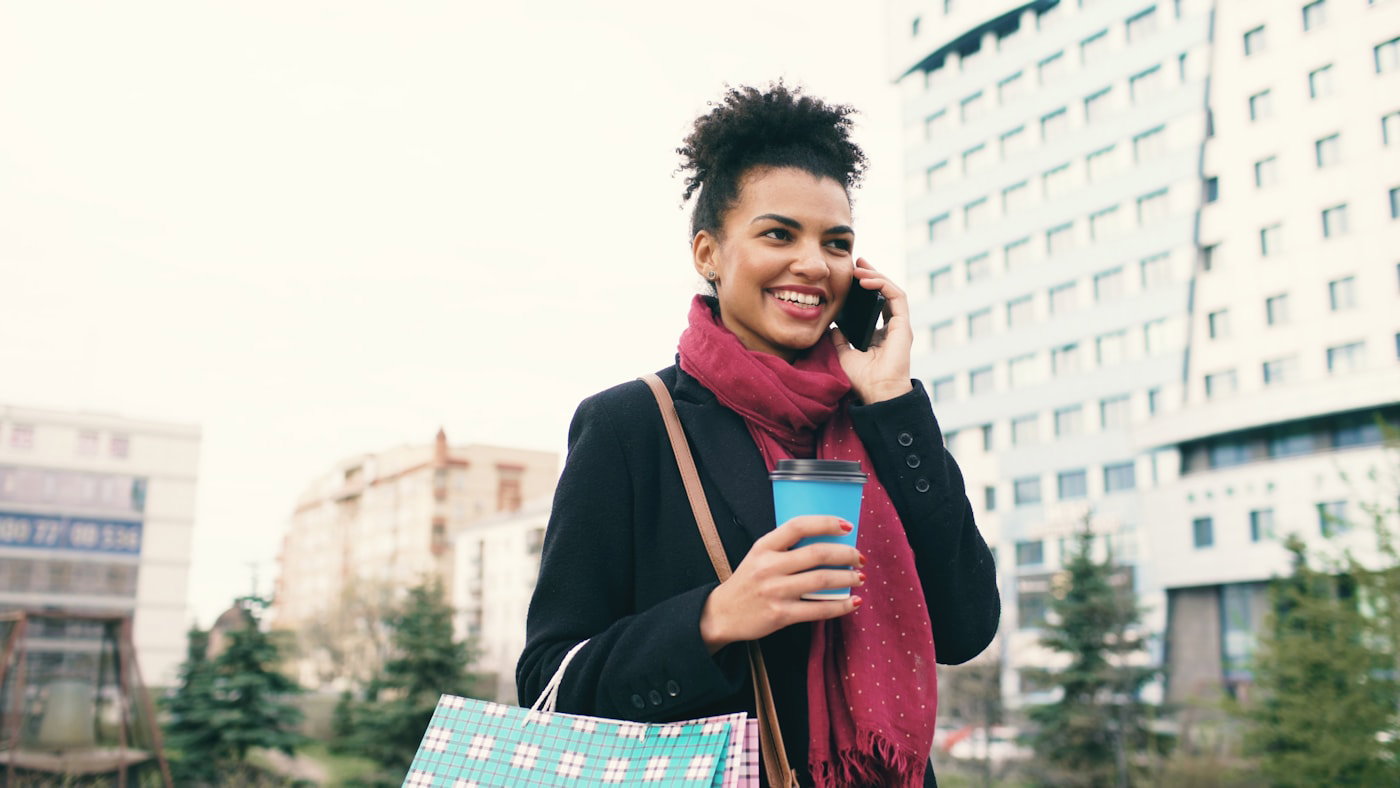 Woman talking on the phone on a city sidewalk